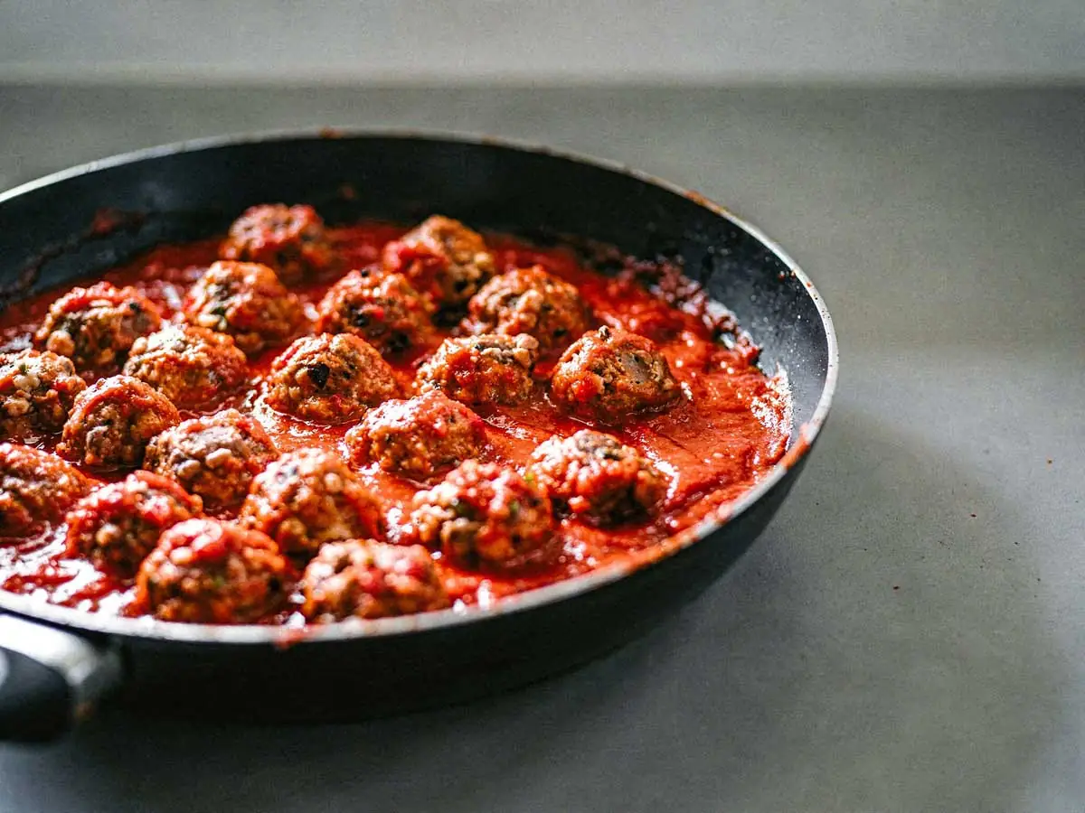 Een koekenpan vol met Italiaanse gehaktballetjes.