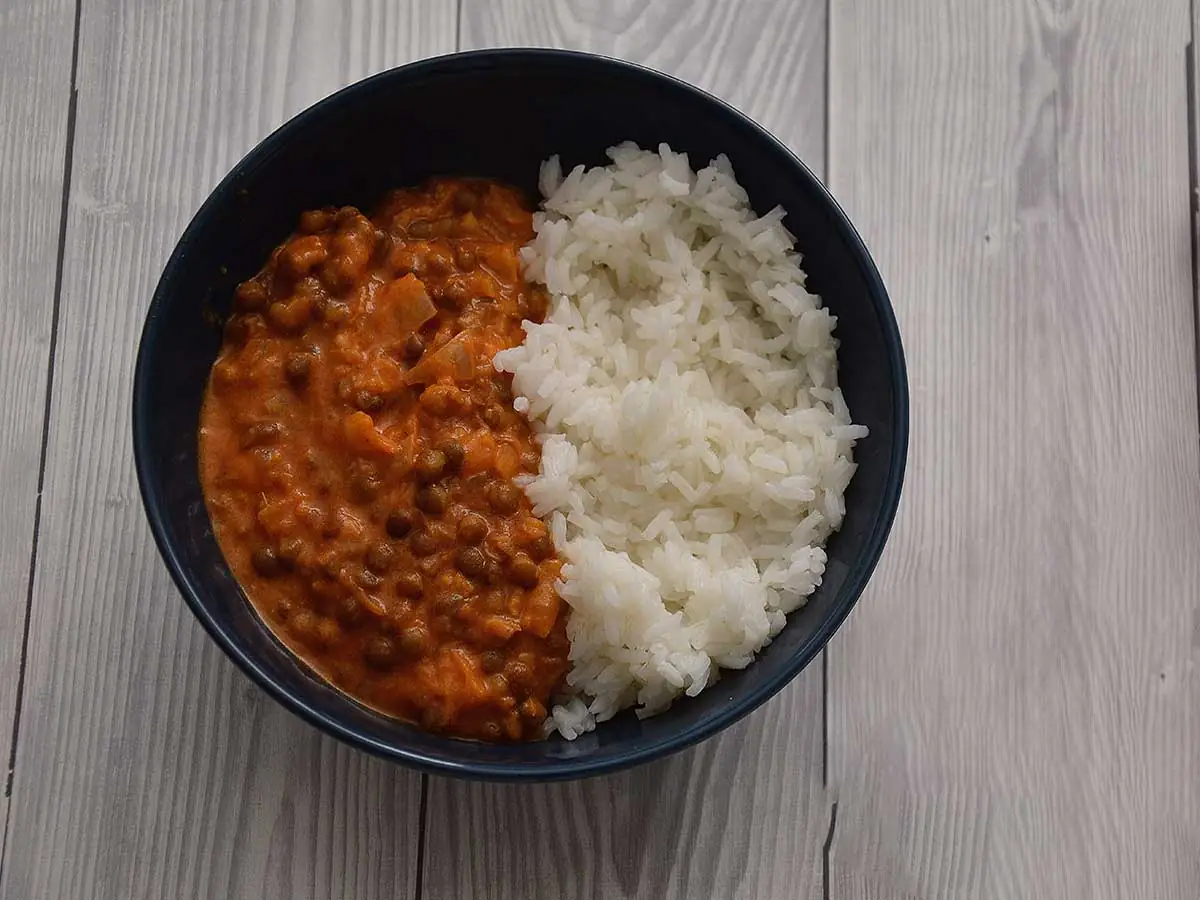 Linzencurry in een blauw schaaltje met witte rijst.